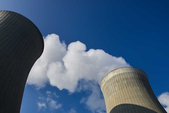 Low,Angle,View,On,Cooling,Towers,With,Water,Steam,On