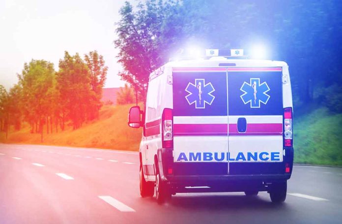 1011860305 featured image Ambulance driving on road with lights flashing.
