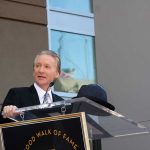 Comedian and talk show host Bill Maher at a podium