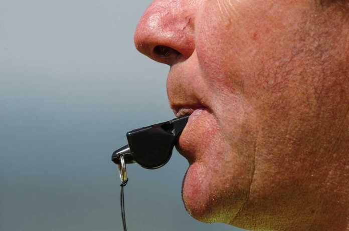 172952840 featured image Person blowing a whistle close-up.