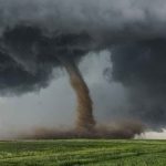 image of a tornado in a field