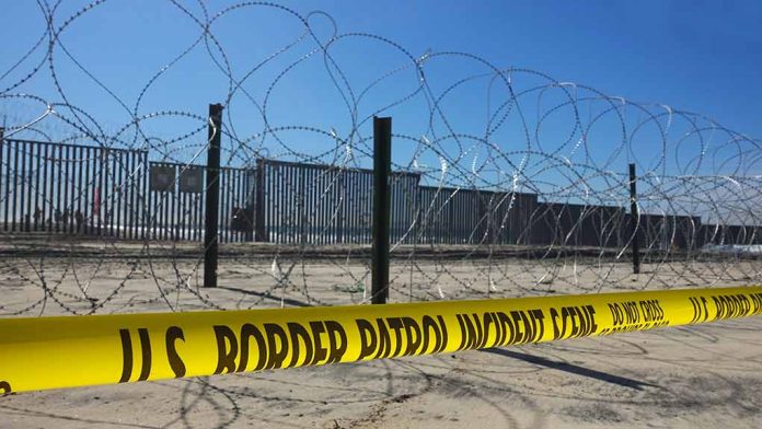 1242590464 featured image Border patrol tape and barbed wire fence.
