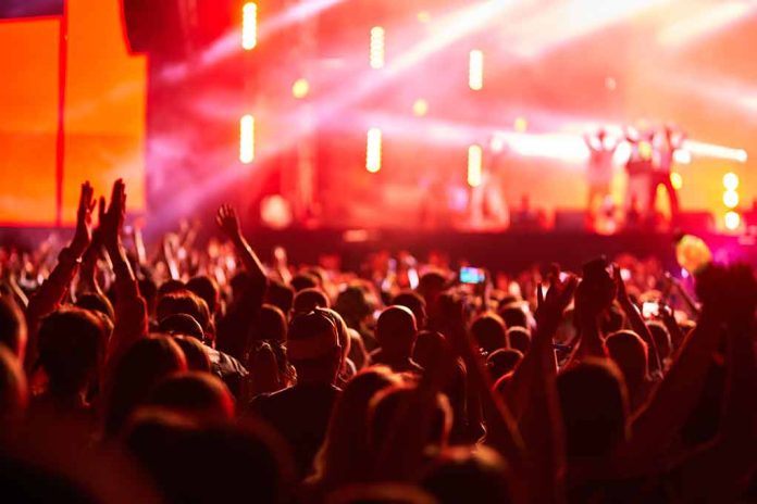 2454781497 featured image Crowd at concert with vibrant stage lights.