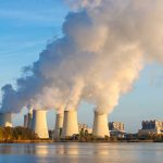 Nuclear power plant cooling towers emitting steam.