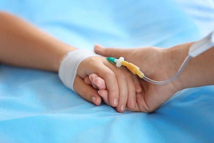 531203017 featured image Two hands holding, one with medical IV attached.