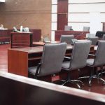 Empty courtroom with desks and chairs.