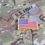 U.S. Army uniform with American flag patch.
