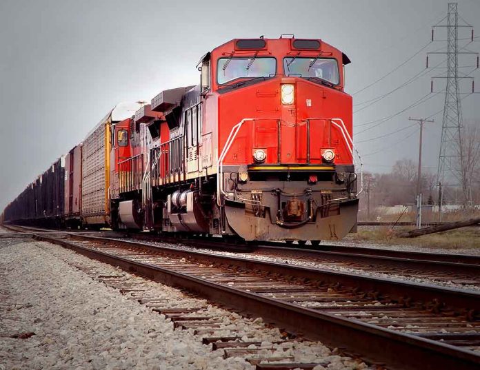 617683550 featured image Red freight train on railroad tracks.