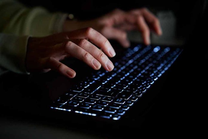 2244182461 featured image Hands typing on a backlit keyboard in darkness