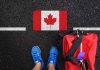 Shoes and bag beside painted Canadian flag.