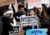Prolife rally with people holding signs and banners