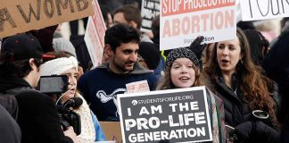 Prolife rally with people holding signs and banners