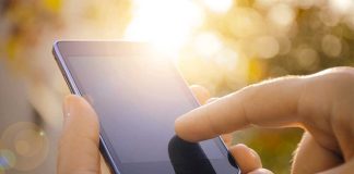 Close-up of a hand using a touchscreen smartphone.