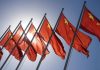 Red flags with yellow stars on flagpoles.