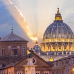 Sunset light behind historic domed cathedral building