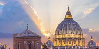 Sunset light behind historic domed cathedral building