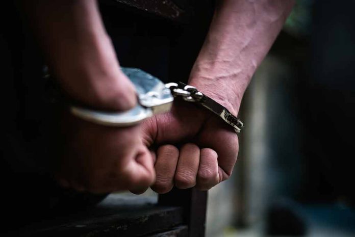 1338116366 featured image Hands in handcuffs behind back close up