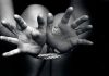 Open hands tied with rope in black and white