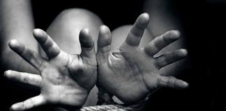 Open hands tied with rope in black and white