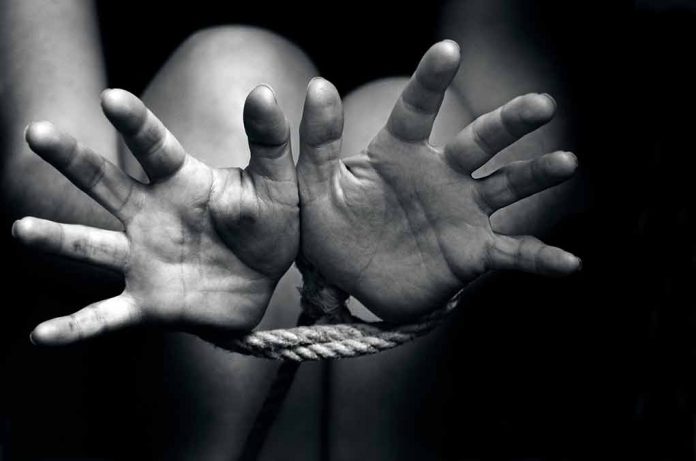 146428184 featured image Open hands tied with rope in black and white