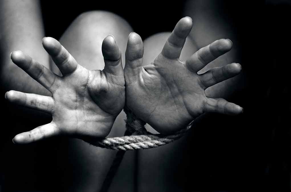 Open hands tied with rope in black and white