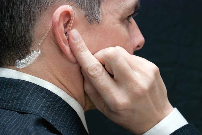 172646540 featured image Man wearing an earpiece touching his ear