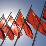 Red flags with yellow stars on flagpoles
