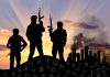 Silhouetted armed figures with city and skulls