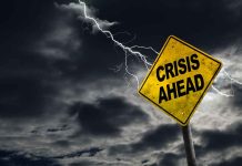 Crisis Ahead sign against stormy sky with lightning