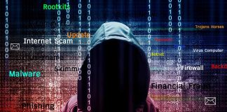 Hooded figure with cybersecurity related words and binary code