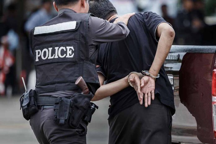 693957643 featured image Police officer arrests handcuffed person