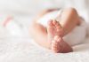 Close up of baby feet lying on blanket