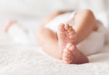 Close up of baby feet lying on blanket