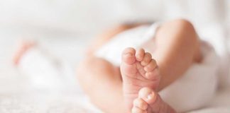 Close up of baby feet lying on blanket