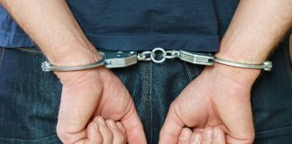 Person in handcuffs behind their back
