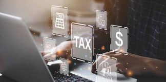 Person typing on laptop with tax related icons displayed