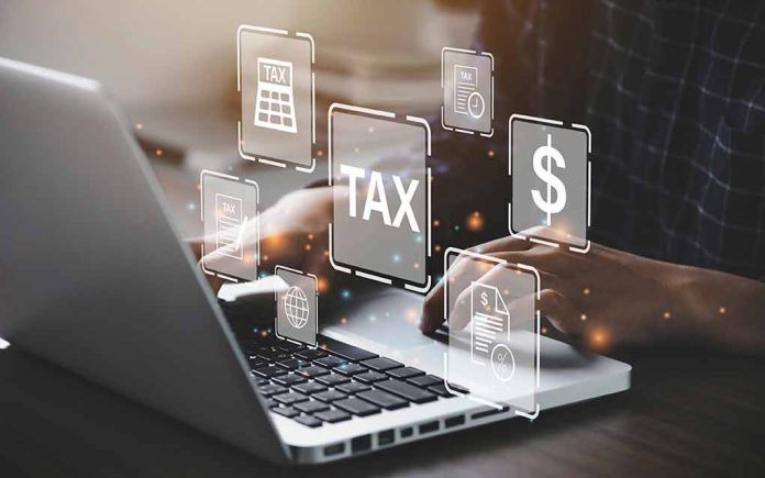 2018230646 featured image Person typing on laptop with tax related icons displayed