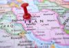 Red pushpin marking Iran on a map