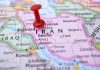 Red pushpin marking Iran on a map