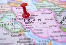 Red pushpin marking Iran on a map