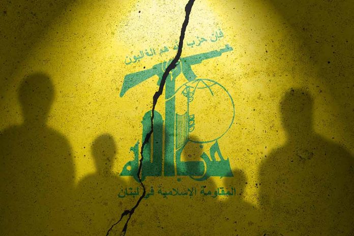 2373422413 featured image Yellow wall with cracked logo and shadowy figures