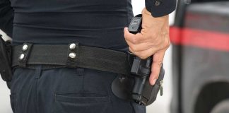 Person holding a gun in a holster