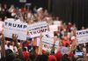 Crowd holding signs supporting Trump at a rally