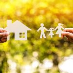 Paper cutouts of a house and family outdoors