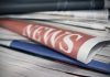 Stack of newspapers with NEWS headline visible