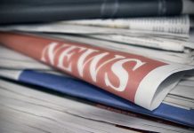 Stack of newspapers with NEWS headline visible