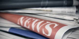 Stack of newspapers with NEWS headline visible