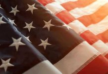 Close up of American flag with sunlit background