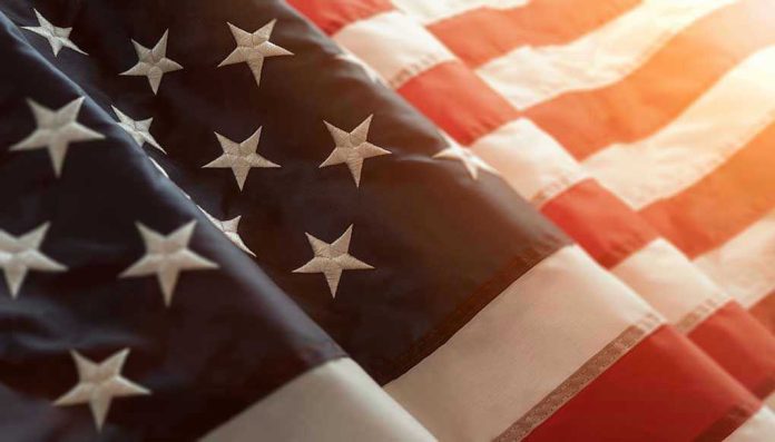 1071381386 Close up of American flag with sunlit background