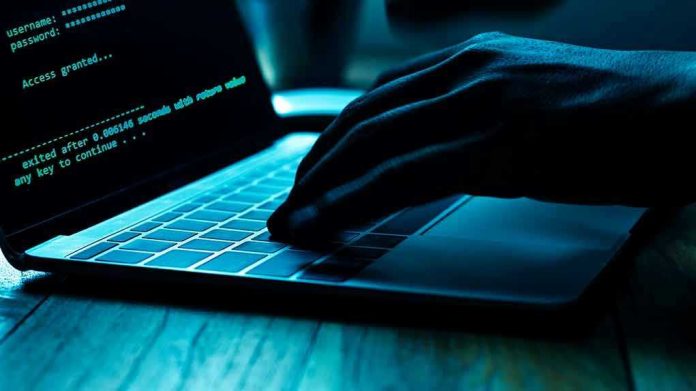 1166453734 Hand typing on laptop with code on screen.